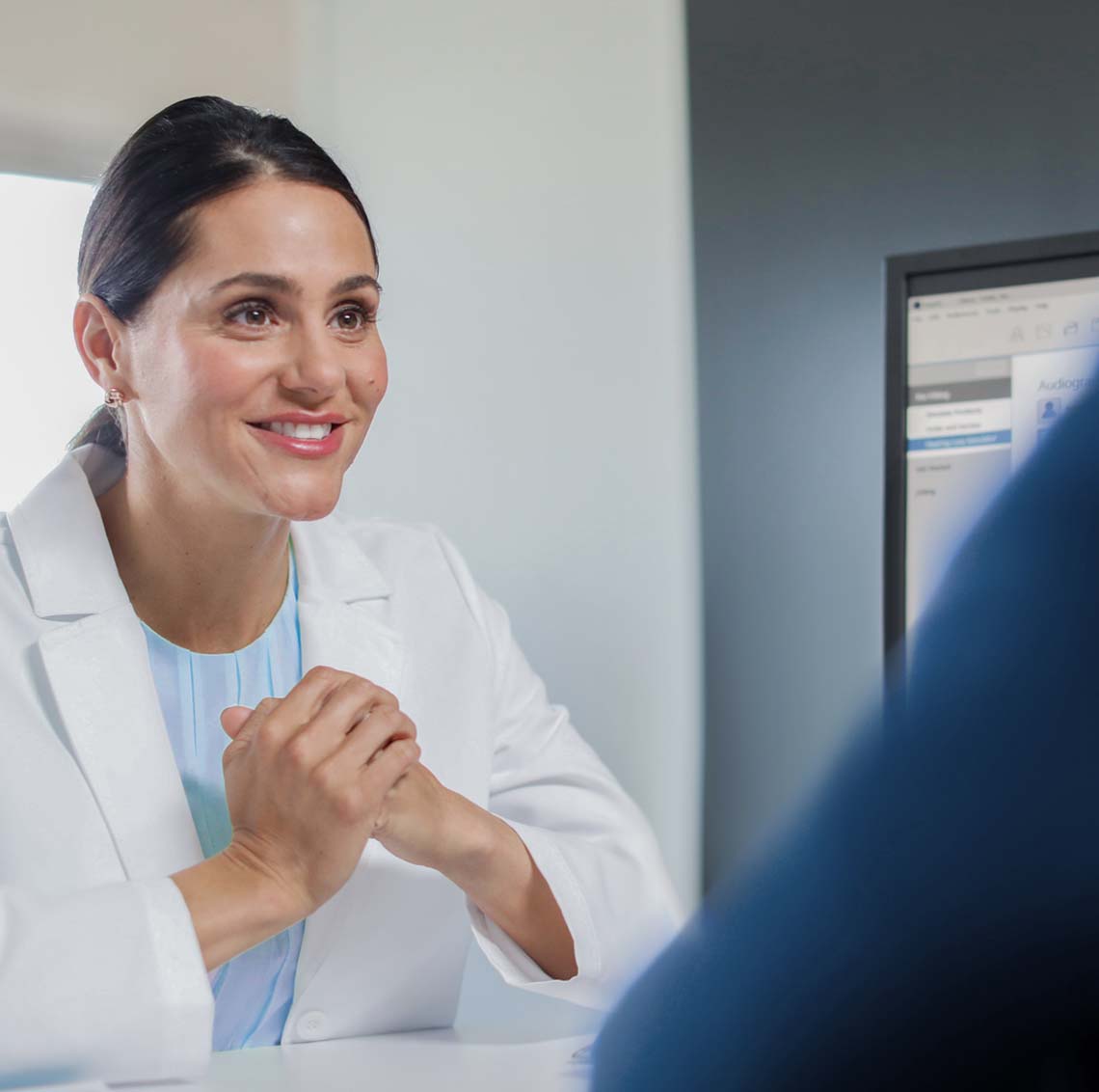 Hearing professional talking with patient