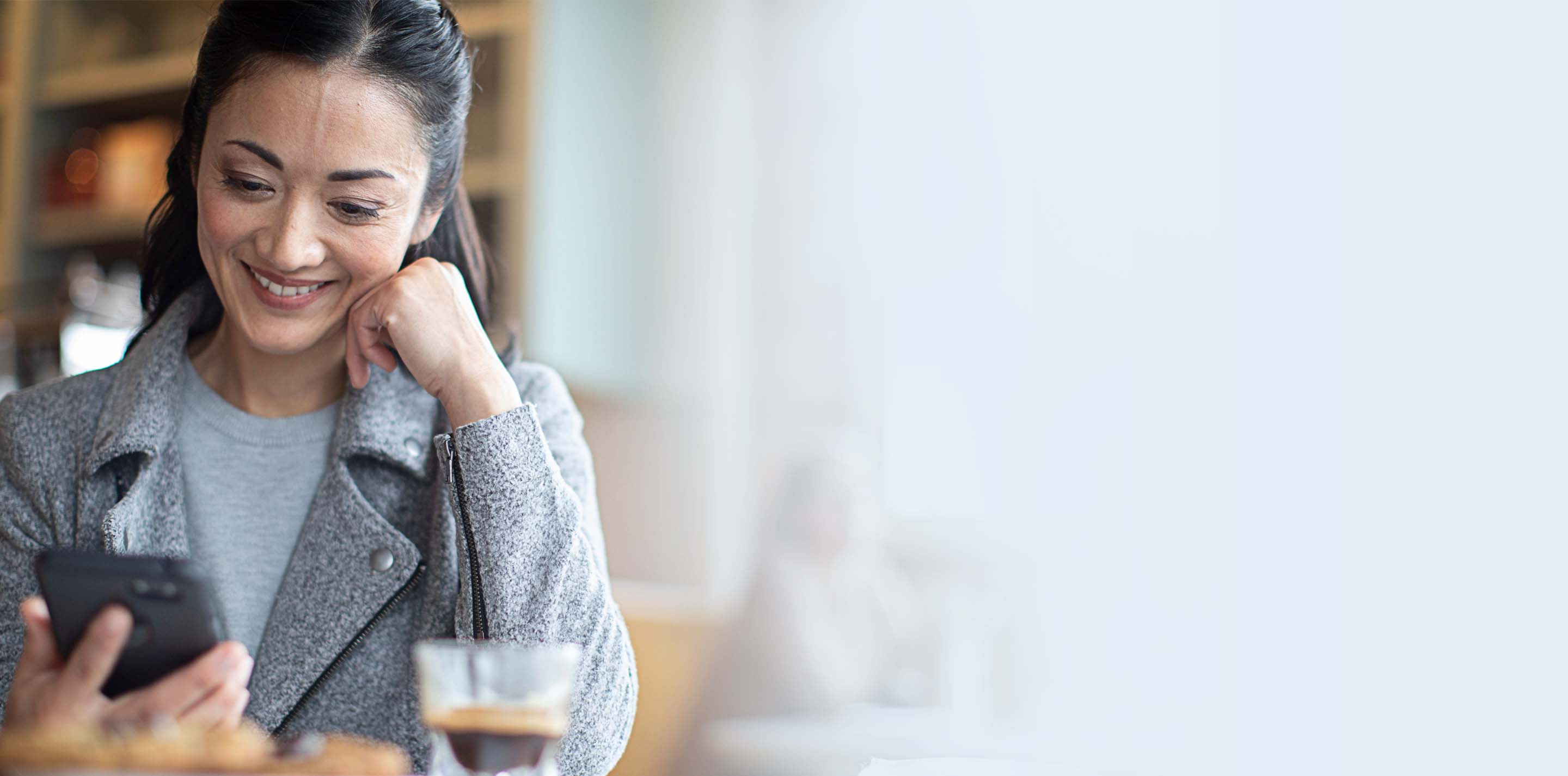 Woman using the Starkey Thrive Hearing Control app